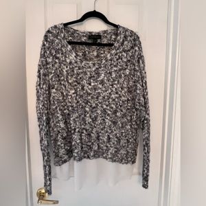 Long sleeve black, grey and white sweater with sheer white bottom layer.